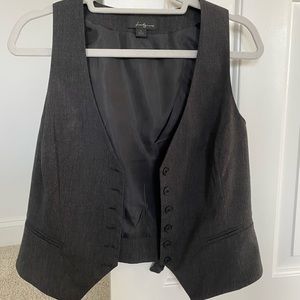 Black vest with front button closure